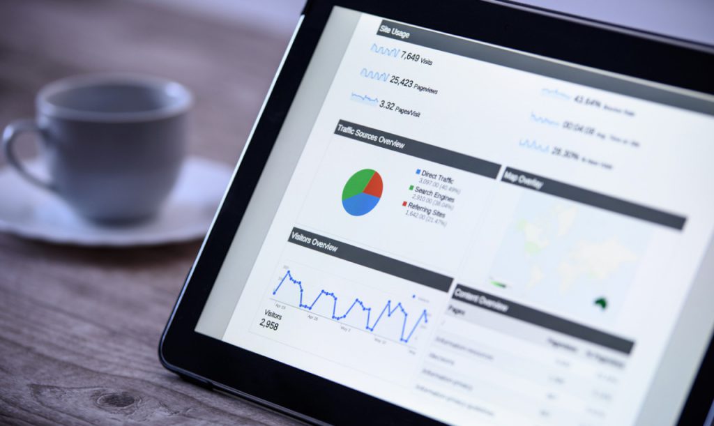 Tablet screen is displaying Google Analytics data.