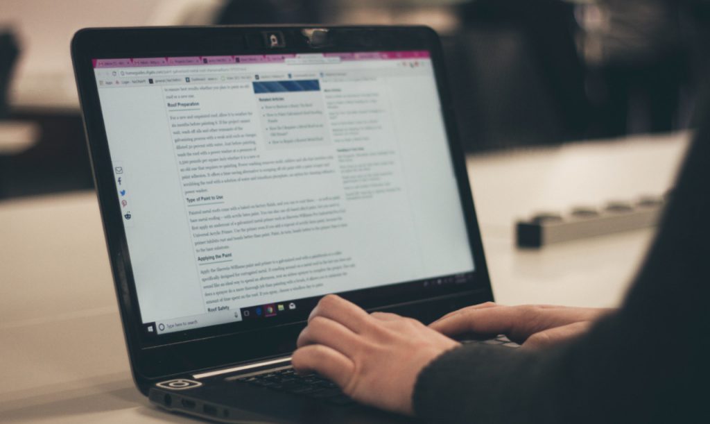 Person typing on a laptop.