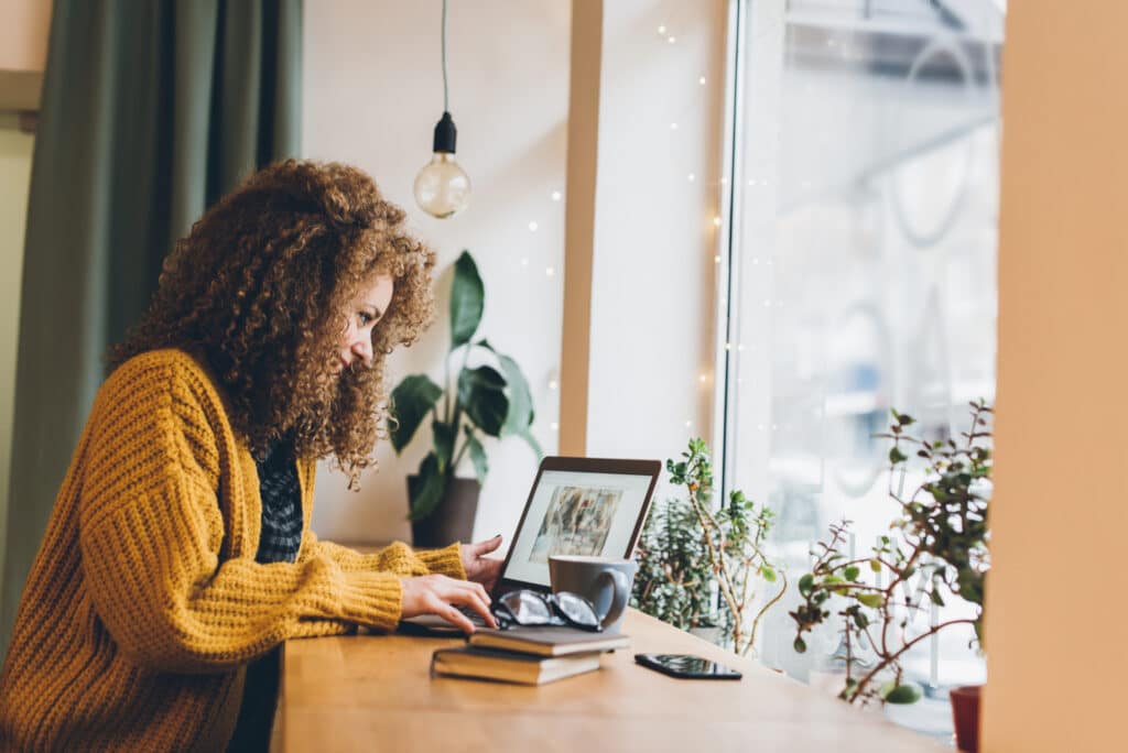 Woman working on a laptop.